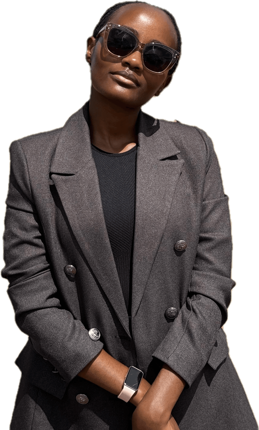 Ana Muraya, smiling in sunglasses and a tailored blazer.