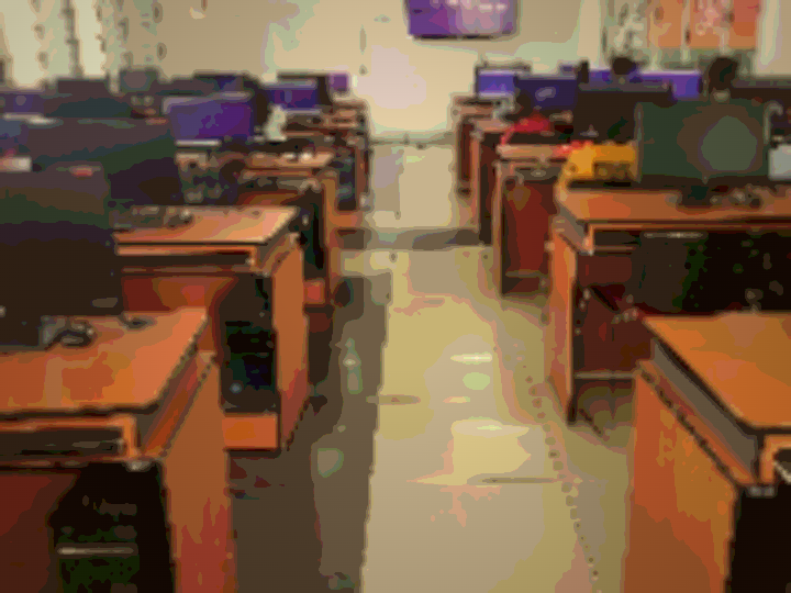 A DigiKids computer lab — rows of desks with monitors running a coding quiz.